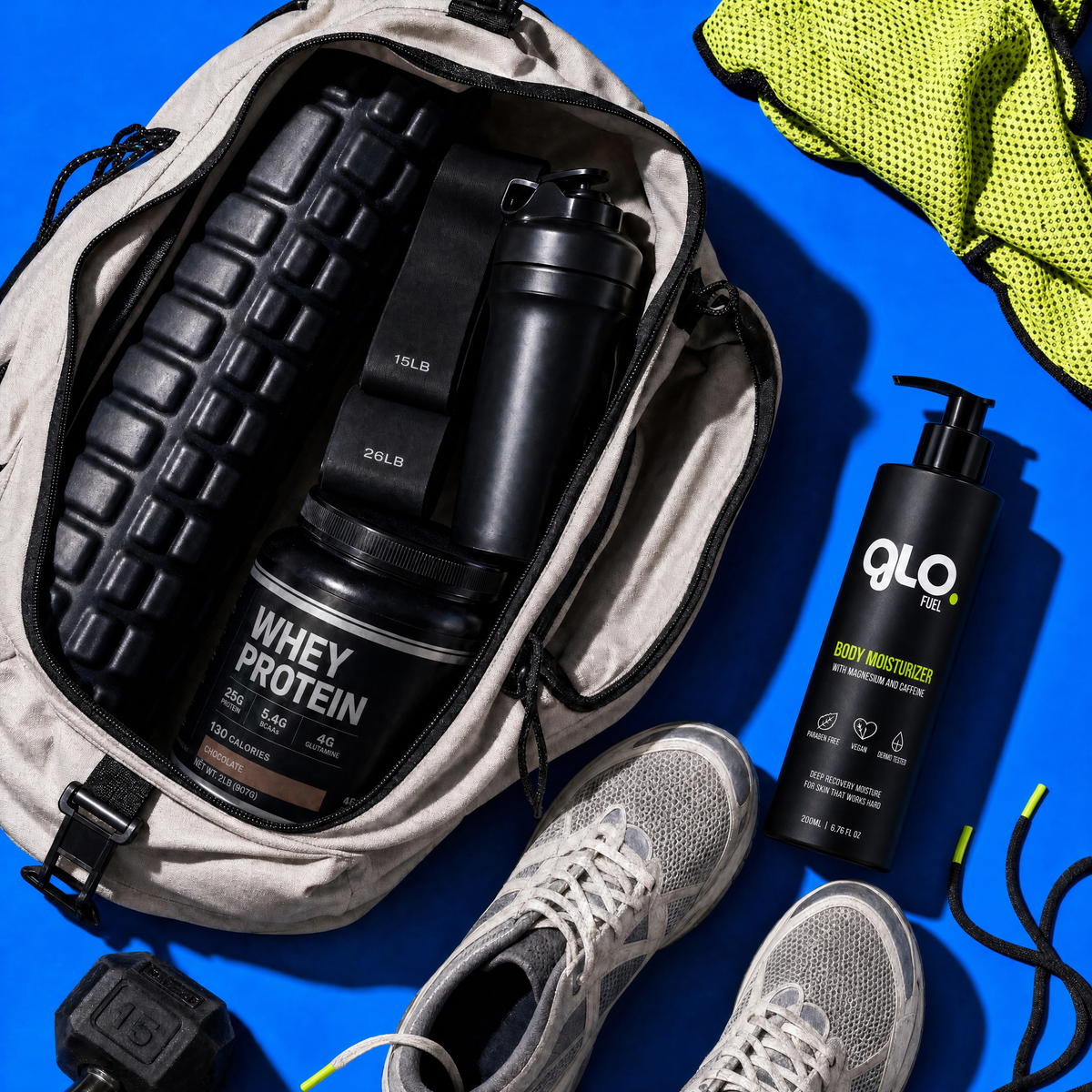 An open beige gym backpack on a bright blue background contains a black shaker bottle, a black tub of whey protein, and a black pump bottle labeled Glo FUEL. Gray athletic shoes and a neon yellow-green towel are arranged around the bag.