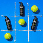 Three black pump bottles of QLO+ Anti-Muscle Pain Relief Cream are arranged on a bright blue background with a white tic-tac grid and four yellow tennis balls. The GLOFUEL brand name is clearly visible on the bottles.