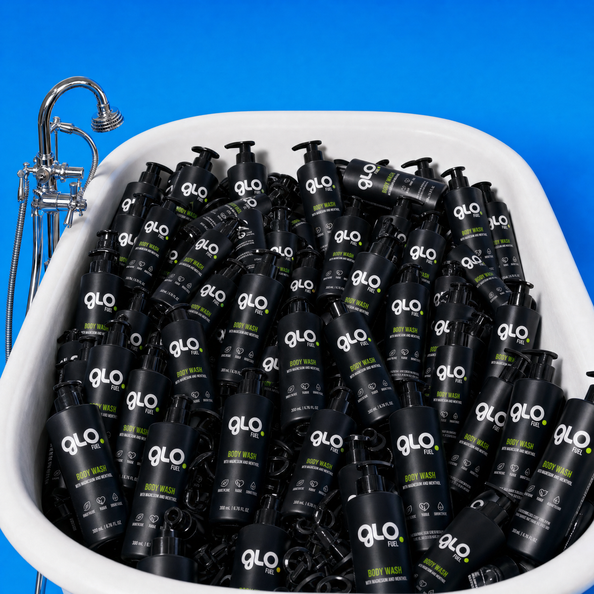A white tub filled with many Glo Body Wash bottles against a bright blue background.